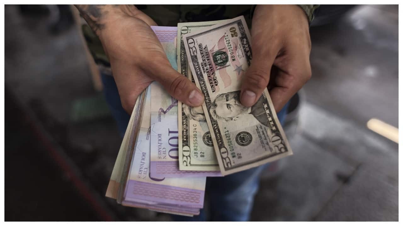 Venezuela moves to resume dollar sales, halting bolivar rout