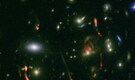 Cosmic lens revealed hyperactive cradle of a future galaxy cluster