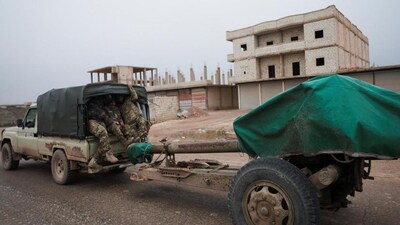 Members of the Syrian army sit in an artillery position on a road near front-line areas, following the withdrawal of Kurdish-led Syrian Democratic Forces in Maskanah, near Aleppo, on January 17, 2026. | Photo Credit: Reuters

