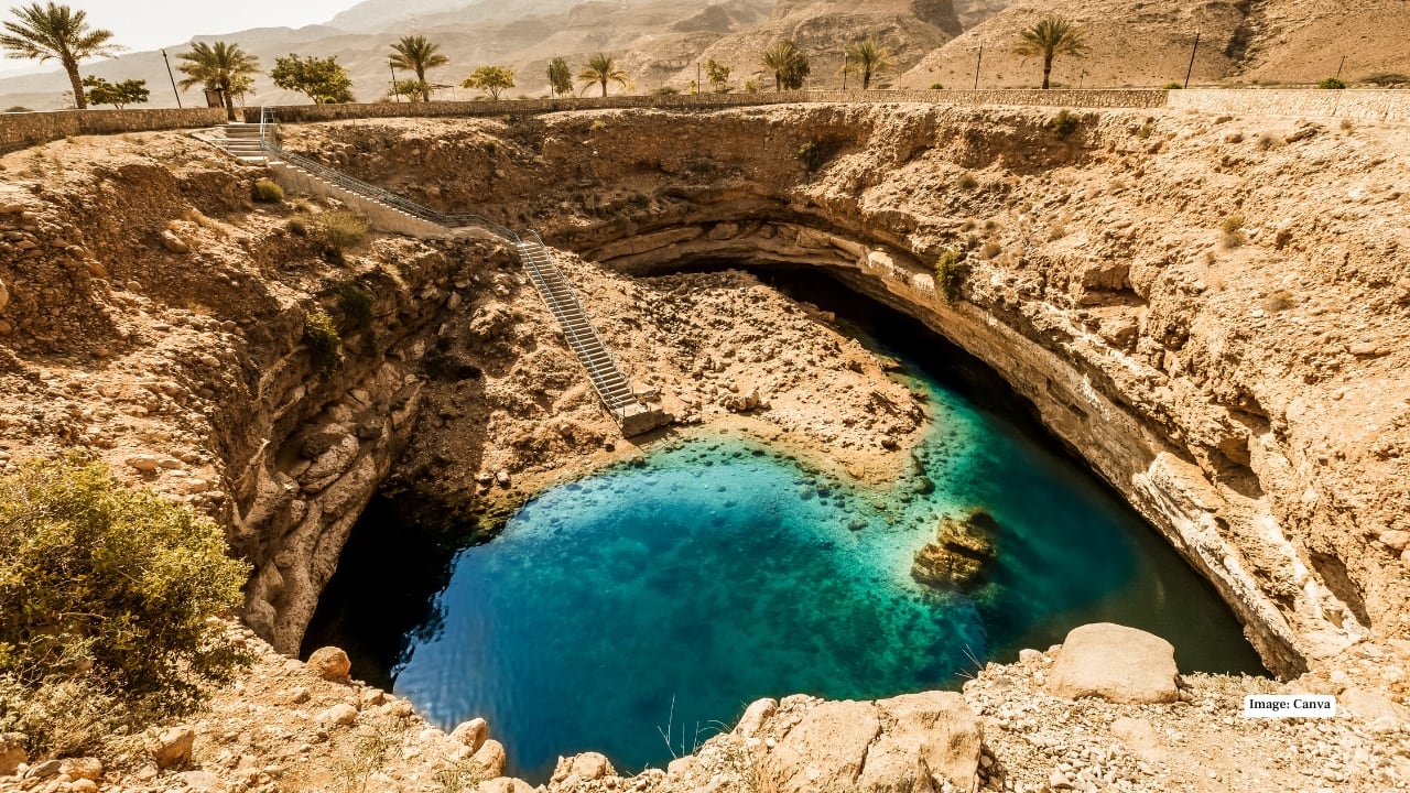 <strong>11. Bimmah Sinkhole – A Natural Limestone Wonder</strong><br />Located between Muscat and Sur, Bimmah Sinkhole is a dramatic limestone crater filled with turquoise water. Legend links it to a falling star, though science credits natural erosion. Visitors can descend steps into the sinkhole for a refreshing swim, making it a popular stop on coastal road trips.