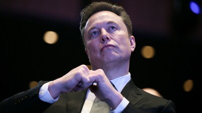 (FILES) Elon Musk looks on as US President Donald Trump speaks at the US-Saudi Investment Forum at the John F. Kennedy Center for the Performing Arts in Washington, DC on November 19, 2025. (Photo by Brendan SMIALOWSKI / AFP)