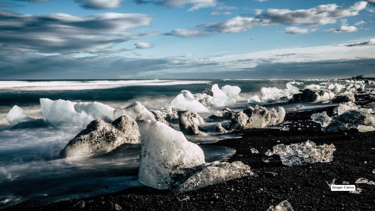 <strong>4. Diamond Beach – Iceland</strong><br />Near Jökulsárlón Glacier Lagoon, chunks of glacial ice scatter across black volcanic sand, sparkling like diamonds in the sunlight. The stark contrast between ice and dark sand creates a surreal Arctic scene.