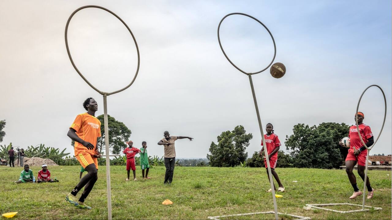Coach John Ssentamu (C), 47, reacts as he scores from the distance as players practice during a training session of Quidditch, also known as Quadball, a sport inspired by the fictional game in the Harry Potter books, in the village of Katwadde, Lwengo District. (Image credit: AFP)