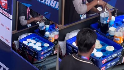 Stadium worker filmed transferring beverages from cups to bottles. (Image: @Warlock_Aditya/X)
