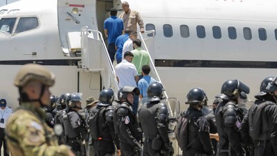 Detained Venezuelans board a flight to Venezuela as part of a detainee exchange agreement between Venezuela and United States on July 18, 2025 in La Paz, El Salvador. 