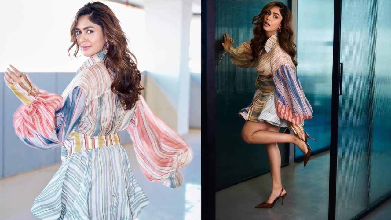 Boho-chic Embracing a whimsical vibe, Mrunal wears a multi-colored striped mini dress defined by exaggerated puff sleeves. The varying vertical and horizontal lines create a dynamic visual texture, while the cinched waist provides structure to the flared skirt. Paired with classic brown slingback heels, it is a perfect blend of fun and femininity.