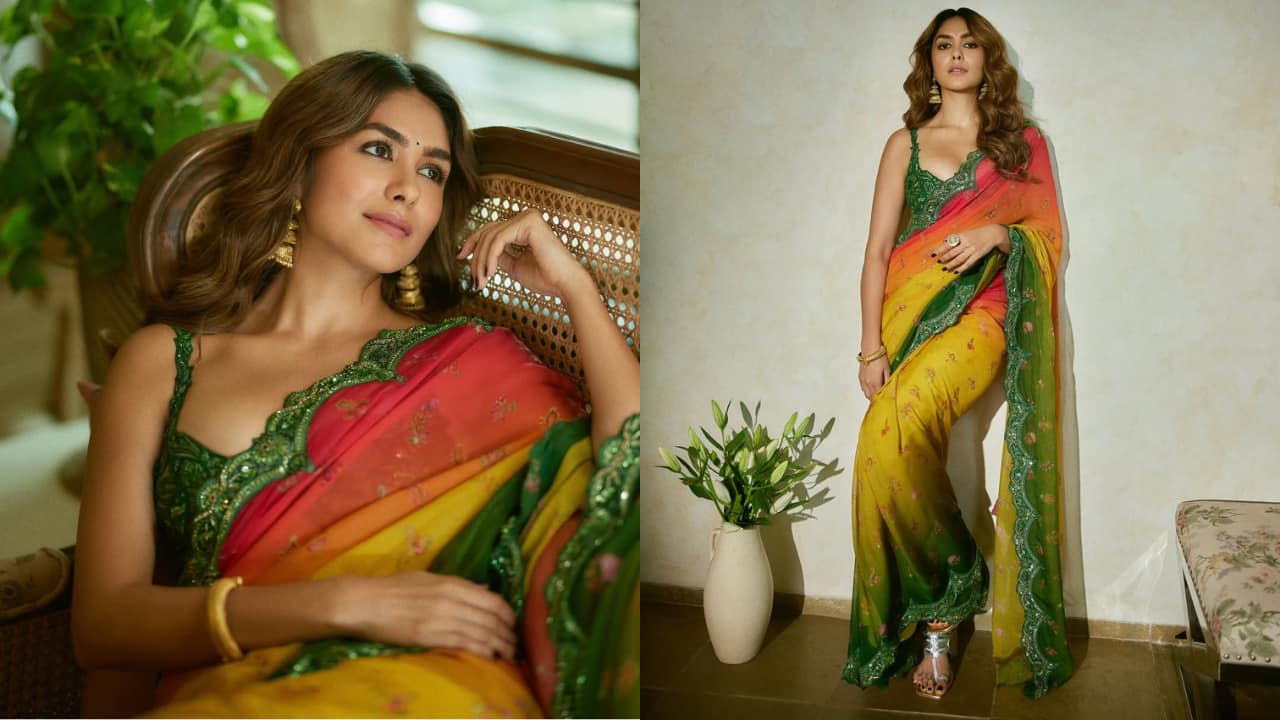 Multi-colored ombre saree Mrunal embraces traditional elegance in a vibrant ombre saree that beautifully transitions through shades of green, yellow, orange, and pink. Adorned with intricate floral embroidery and gold accents, the saree is paired with a richly detailed green sleeveless blouse. This look was specifically curated as a graceful ode to divine femininity.