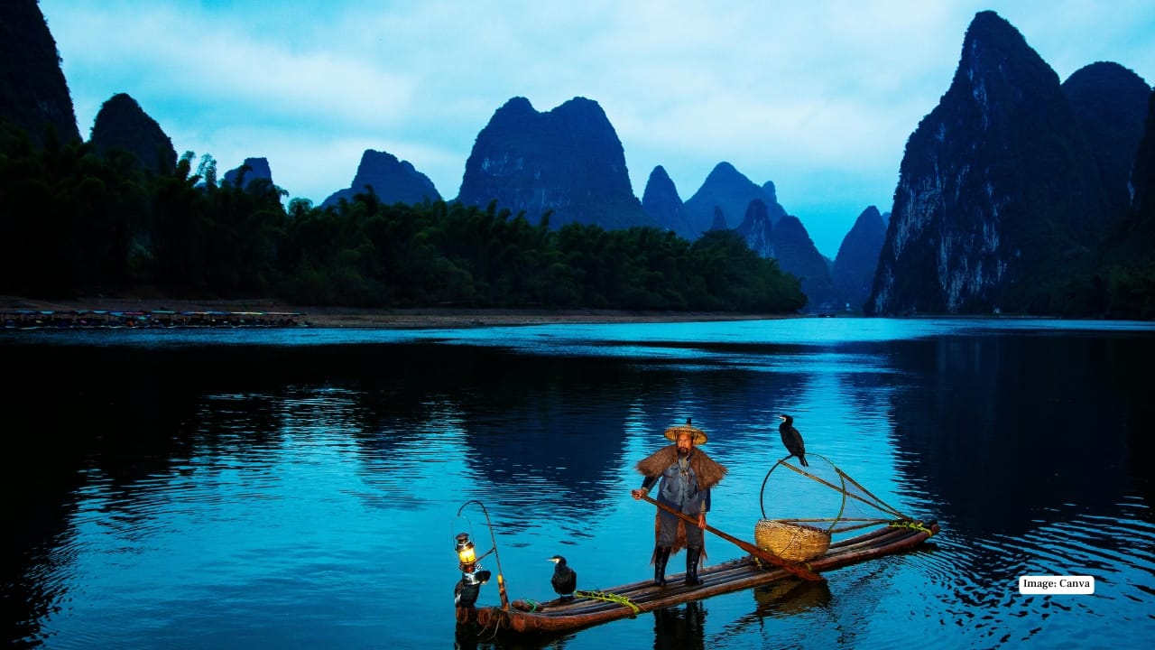 5. Li River, Guilin A cruise along the Li River between Guilin and Yangshuo reveals landscapes that seem lifted from a classical Chinese painting. Limestone karst peaks rise sharply from mist-covered waters, fishermen drift by on bamboo rafts, and water buffalo graze along the banks. The scenery shifts gently, almost theatrically, with every bend of the river.