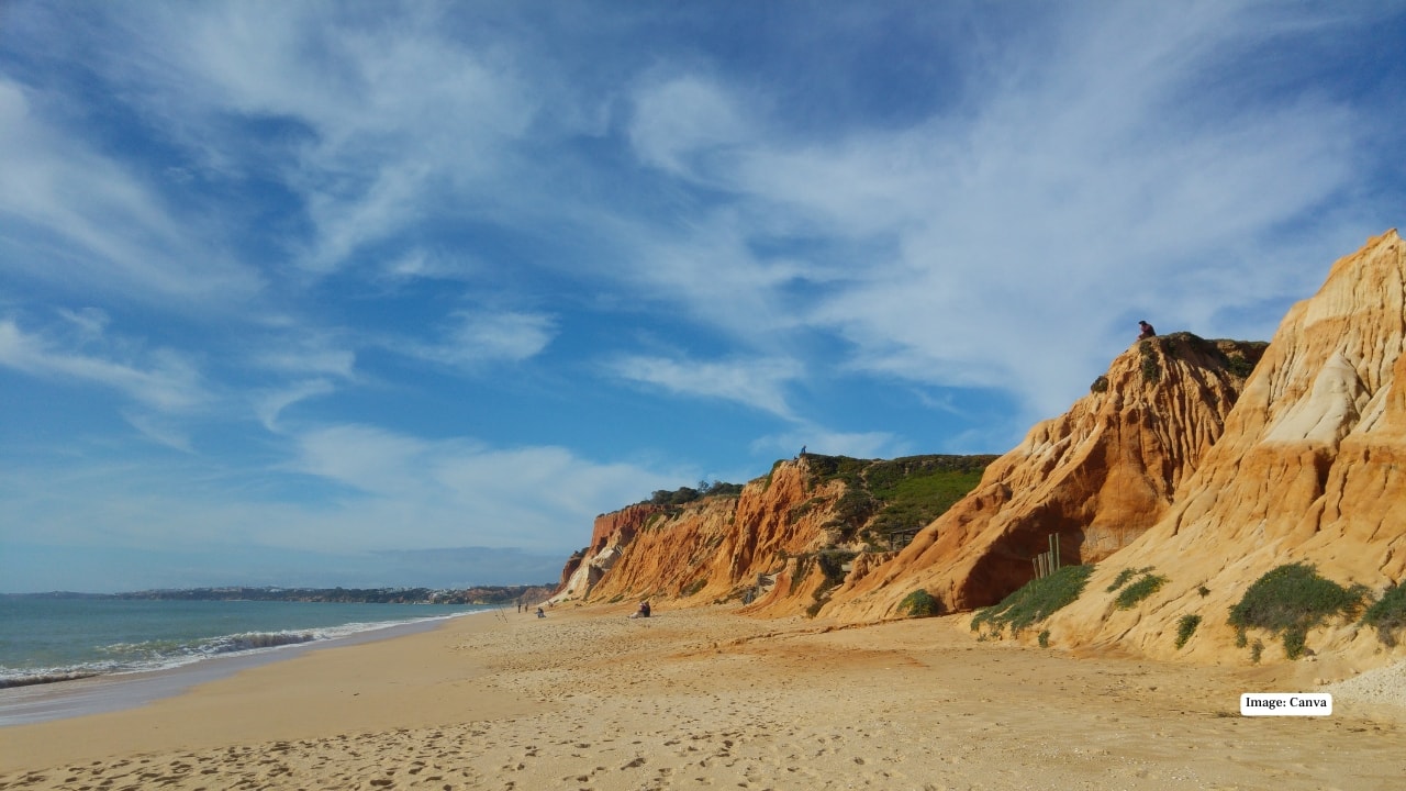 <strong>5. Praia da Falésia, Portugal</strong><br />Located in Olhos de Água, Praia da Falésia is recognised for its dramatic red and ochre cliffs rising above golden sand. The expansive shoreline allows visitors to sunbathe comfortably, while surfers and swimmers take advantage of the Atlantic waves. A scenic cliff-top trail offers panoramic views, adding a hiking element to the beach experience.