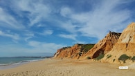 <strong>5. Praia da Falésia, Portugal</strong><br />Located in Olhos de Água, Praia da Falésia is recognised for its dramatic red and ochre cliffs rising above golden sand. The expansive shoreline allows visitors to sunbathe comfortably, while surfers and swimmers take advantage of the Atlantic waves. A scenic cliff-top trail offers panoramic views, adding a hiking element to the beach experience.