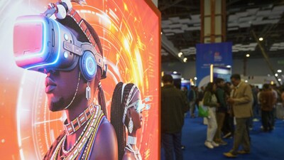 Visitors stand next to an advertising billboard at AI summit in New Delhi. (AP Photo)