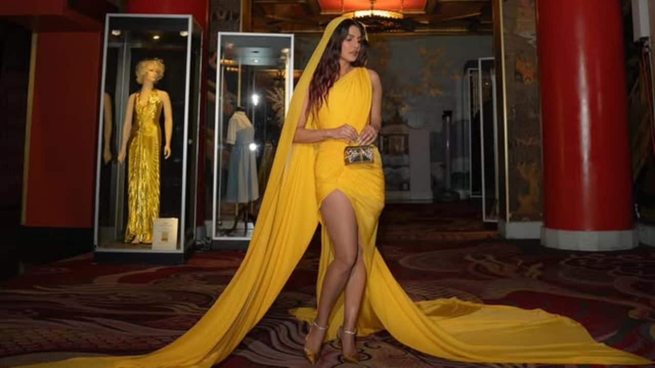 Finishing Touches: Glamour in Details<br /> <br /> Priyanka completed the look with golden crystal-strapped stilettos that perfectly complemented the gown’s luminous tone. She further accessorised with statement rings and elegant earrings, maintaining a cohesive gold-accent theme throughout. Finishing Touches: Glamour in Details<br /> <br /> Priyanka completed the look with golden crystal-strapped stilettos that perfectly complemented the gown’s luminous tone. She further accessorised with statement rings and elegant earrings, maintaining a cohesive gold-accent theme throughout.