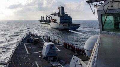 In this handout photograph released by the US Navy, the Arleigh Burke-class guided-missile destroyer USS Frank E. Petersen Jr. (DDG 121) sails alongside fleet replenishment oiler USNS Henry J. Kaiser (T-AO-187), during a replenishment-at-sea in the Arabian Sea on February 18, 2026. (Photo by Christian Kibler / US NAVY / AFP) / RESTRICTED TO EDITORIAL USE - MANDATORY CREDIT "AFP PHOTO / U.S. NAVY" - HANDOUT - NO MARKETING NO ADVERTISING CAMPAIGNS - DISTRIBUTED AS A SERVICE TO CLIENTS