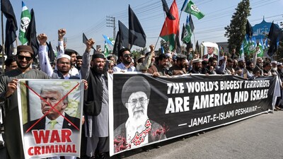 Activists and supporters of the Jamaat-e-Islami party shout slogans during an anti-US and Israel protest in Peshawar on March 2, 2026 after the death of Iran's supreme leader Ayatollah Ali Khamenei amid US-Israel strikes. The death toll from Pakistan's violent weekend protests over the killing of Iran's supreme leader has reached at least 25, according to an AFP tally on March 2. (Photo by Abdul MAJEED / AFP)