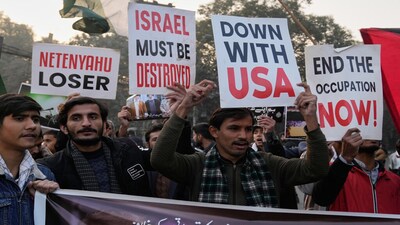 Shiite Muslims hold placards and chant slogans during a protest against the US and show solidarity with Iran in Lahore, Pakistan. (AP)