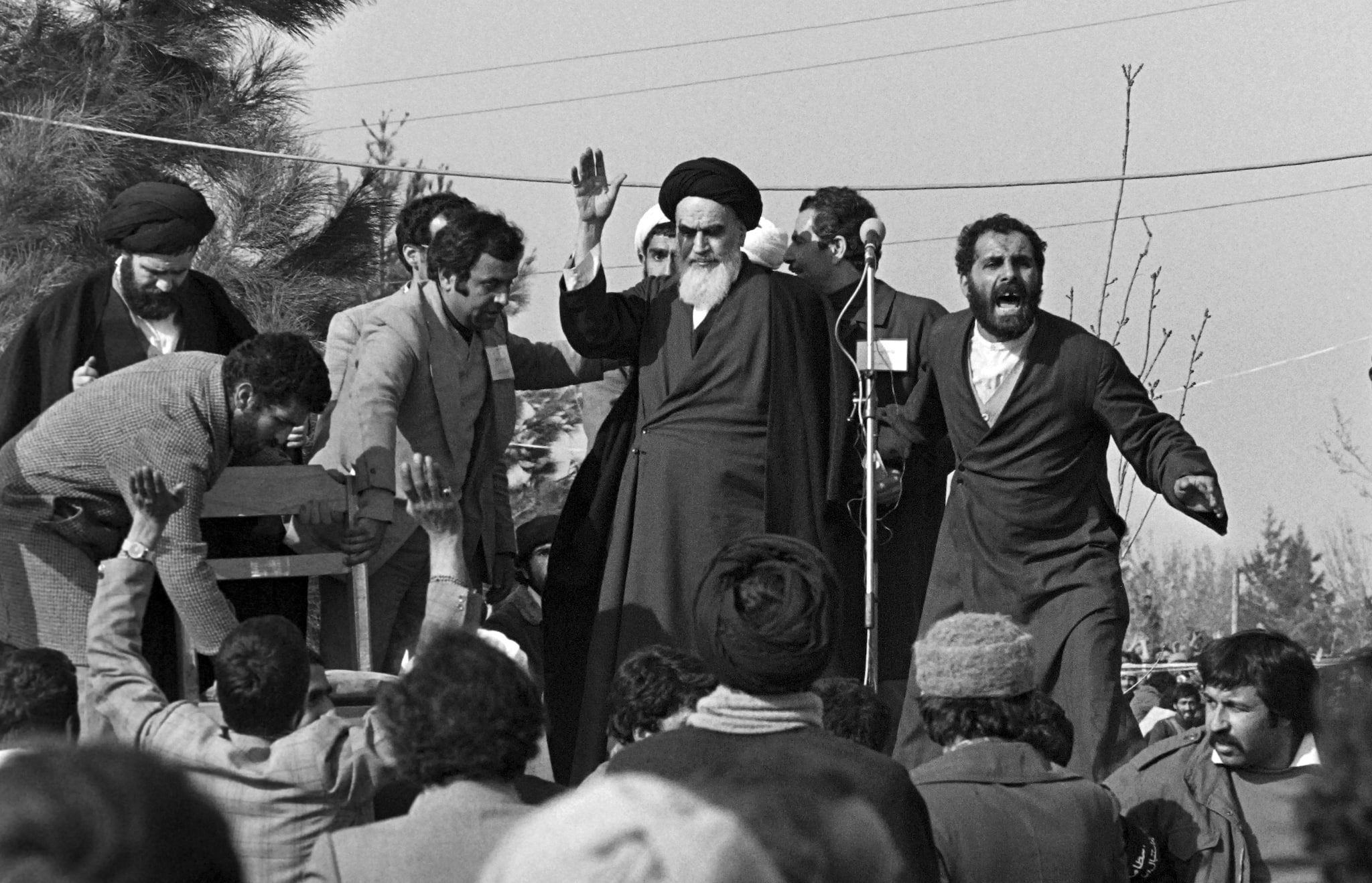 Ayatollah Ruhollah Khomeini waves to a crowd of supporters gathered at the Behechte Zahra Cemetery in Tehran during his visit on the day of his return from France after 15 years of exile, as the insurrection against the Shah's regime spreads all over the country. Khomeini warned the shah, in an inflammatory sermon in 1963, that he risked being overthrown by the people if he continued along his reformist path  a speech that led him to jail. A year later, he was forced into exile following a vehement outburst after the shah had given diplomatic immunity to US military personnel. (Photo by GABRIEL DUVAL / AFP)