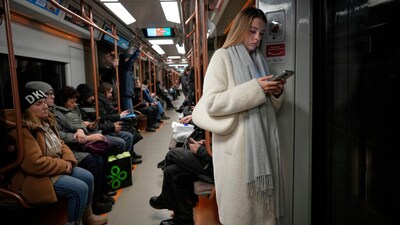 A woman looks at her smartphone on the subway in Moscow, Russia. (AP/File Photo)