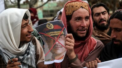 An Afghan protester holds a photograph of Pakistan's Chief of Defence Forces Syed Asim Munir during a demonstration in Ghazni on March 6, 2026 amid the ongoing conflict with Pakistan. (Photo by Mohammad Faisal NAWEED / AFP)