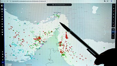 A person points at a page on the Marinetraffic website that shows commercial boats traffic on the edge of the Strait of Hormuz near the Iranian coast (AFP image)