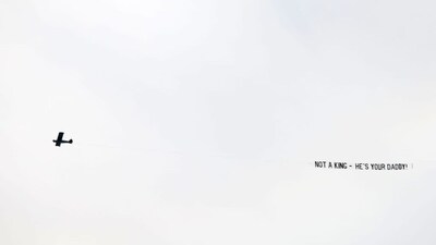 The man flew the banner above 'No Kings' protest