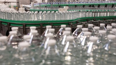 This photograph shows Cristaline bottles before being labelled on the production line of the Cristaline Chantereine mineral water bottling factory in Chelles, East of Paris, on February 27, 2026. (Photo by Thomas SAMSON / AFP)