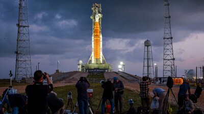 People set cameras to photograph NASA's Artemis II lunar flyby mission, with the next-generation moon rocket, the Space Launch System (SLS) rocket and the Orion crew capsule, on Pad 39B ahead of the launch of the Artemis II mission at the Kennedy Space Center in Cape Canaveral, Florida, U.S.,  March 31, 2026.    REUTERS/Brendan McDermid