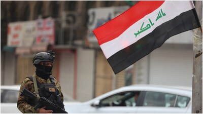 A member of Iraq's Hashed al-Shaabi forces stand guard during a pro-Iran rally in Tahrir Square in Baghdad on April 2, 2026. (AFP)
