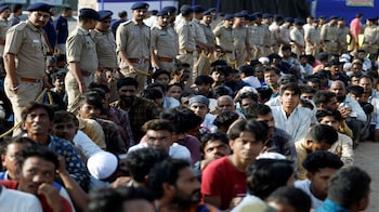 Police officers stand next to men they believe to be undocumented Bangladeshi nationals after they were detained during raids in Ahmedabad. (File photo : Reuters)