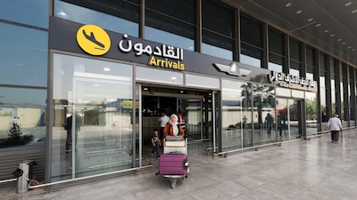 An Iranian passenger carrying luggage leaves Najaf International Airport after arriving on an AVA Airlines flight, in Najaf, Iraq, September 23, 2026. REUTERS/Alaa Al-Marjani
