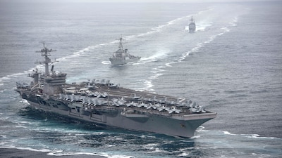 This US Navy photo shows the aircraft carrier USS Theodore Roosevelt (CVN 71), front, the Arleigh Burke-class guided-missile destroyer USS Russell (DDG 59), center, and the Ticonderoga-class guided-missile cruiser USS Bunker Hill (CG 52) transit in formation in the Pacific Ocean. (AFP file photo)