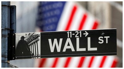 A street sign for Wall Street is seen outside the New York Stock Exchange (NYSE) in New York City (Courtesy: Reuters photo)