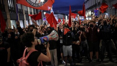 People take part in a protest against fascism and the housing crisis in Puerta del Sol square, where a camp has been set up, demanding political action to stop evictions and address the housing crisis, following the eviction of an 87-year-old woman from her home, in Madrid, Spain, October 3, 2026. REUTERS/Alejandro Martinez Velez
