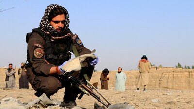 FILE PHOTO: A member of the Taliban security forces inspects metal debris at the site of a partially damaged house following what Taliban officials say was a Pakistani airstrike in Gurbuz district, Khost province, Afghanistan, September 24, 2026. REUTERS/Stringer/File Photo
