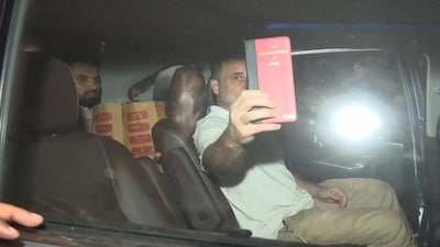Senior Congress leader Rahul Gandhi poses with a copy of the Constitution of India after he was released from the New Police Lines at Kingsway Camp in Delhi on Tuesday.