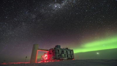 IceCube Observatory at the South Pole beneath the southern lights.