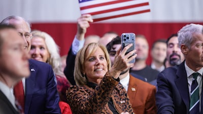 U.S. Rep. Claudia Tenney (R-NY) listens as U.S. President Donald Trump speaks on stage during a midterm election rally (AFP image)