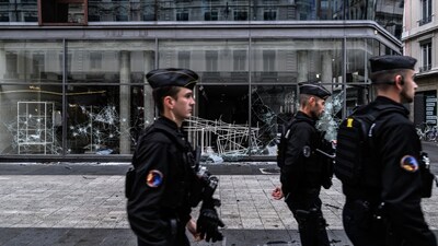 France reports around 1,800 arrests after violent protests over the cost of living. Paris police say a record 855 people were arrested amid looting, fires and clashes. (Image: AFP)